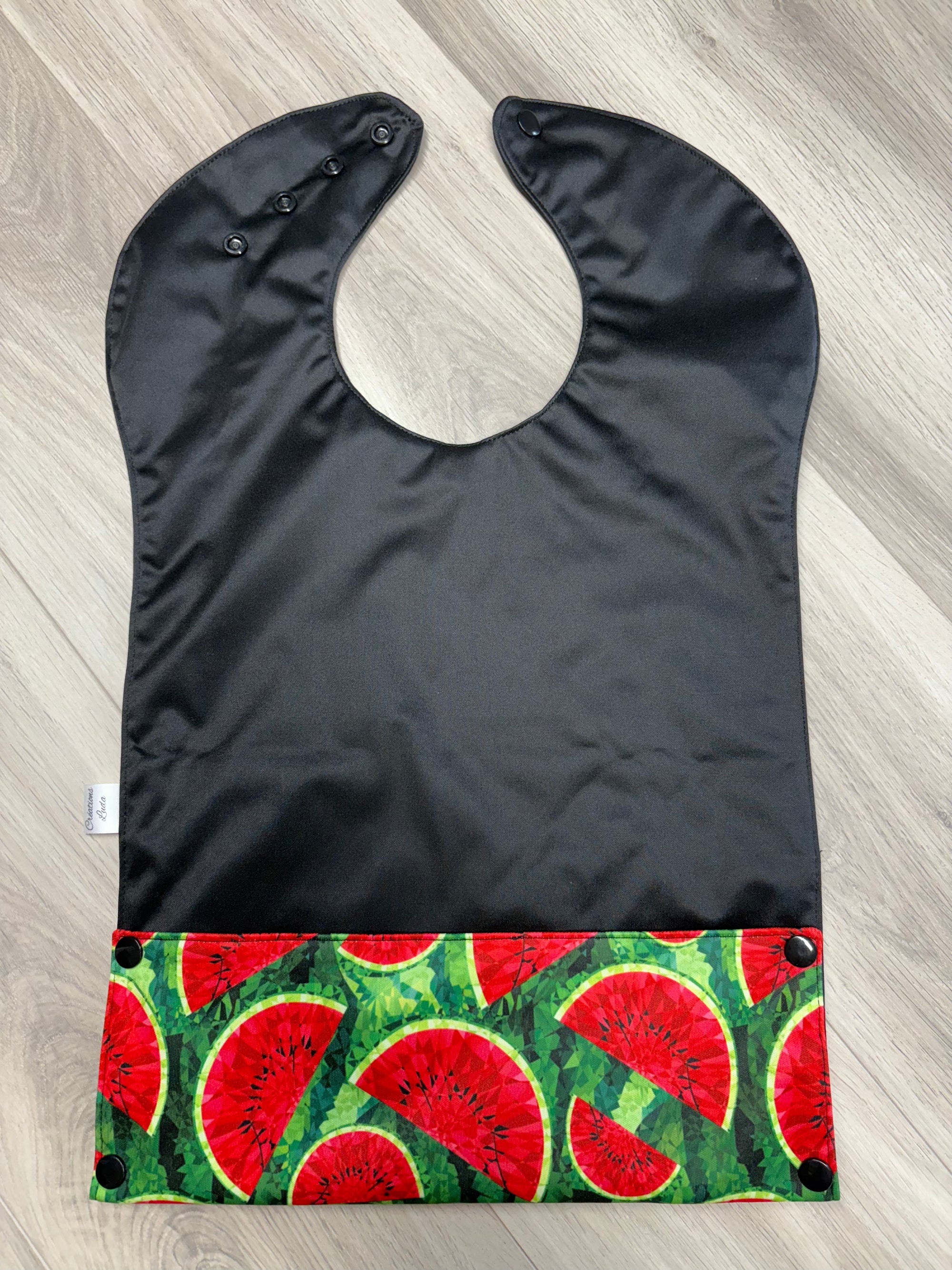 Bavette imperméable évolutive 1 à 4 ans :  noire et melons