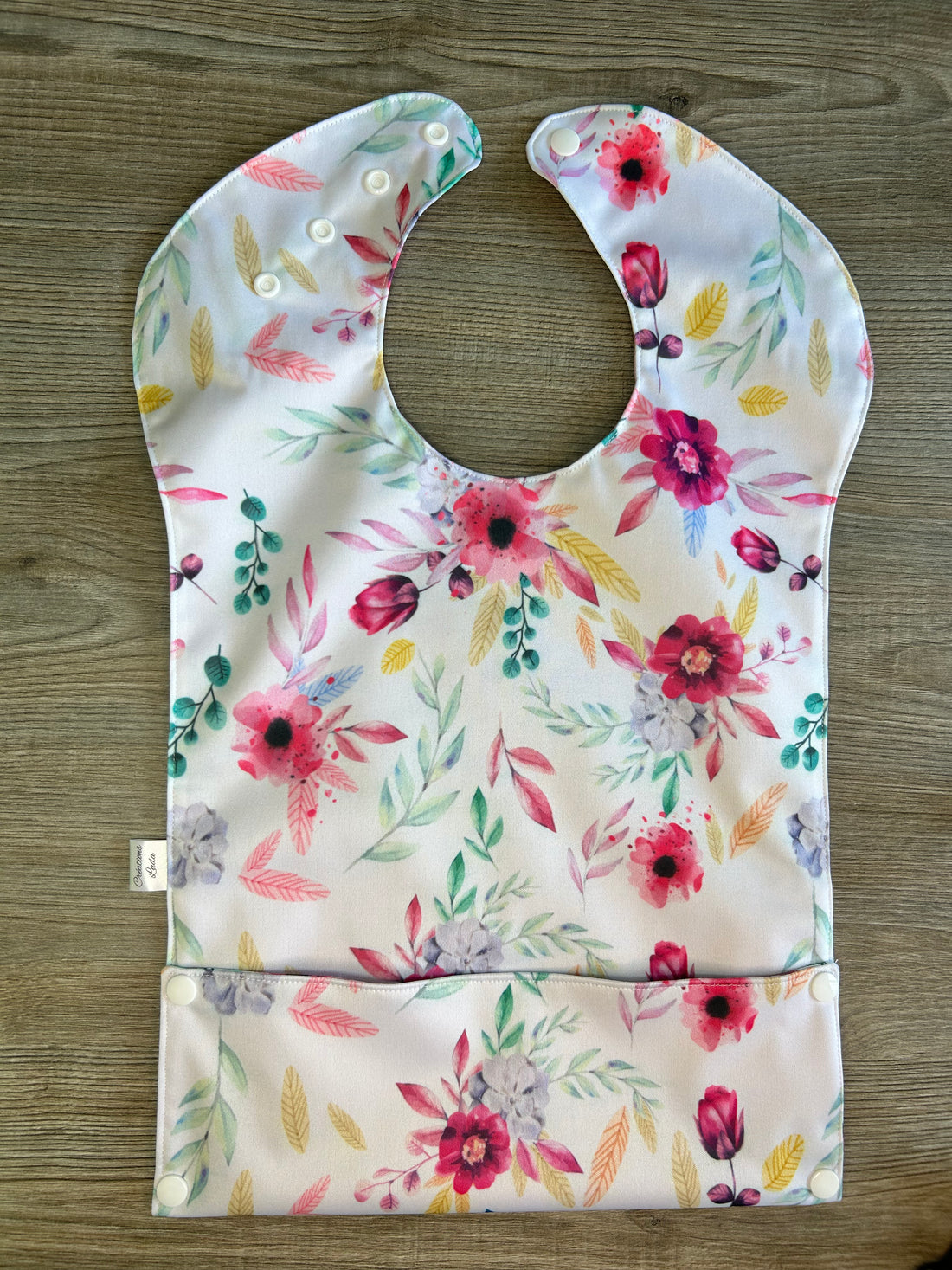 Bavette imperméable évolutive 1 à 4 ans : fleurs roses